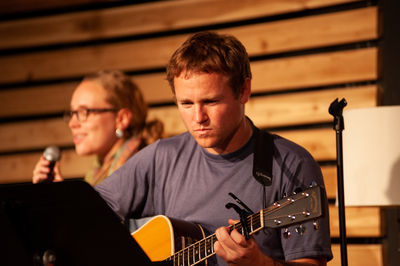 Jacoby leads worship with guitar