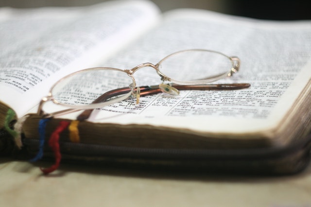 Glasses on top of a bible